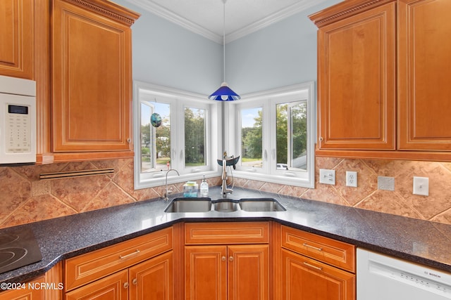 kitchen featuring crown molding, white appliances, plenty of natural light, and sink