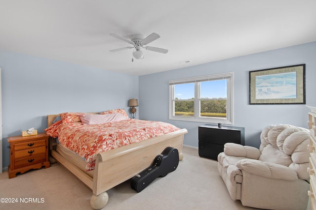 bedroom with ceiling fan and light carpet