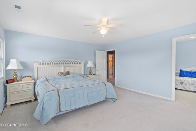 bedroom with ceiling fan and light colored carpet