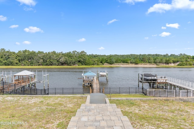 dock area featuring a water view and a yard