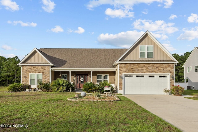 view of front of home with a front yard and a garage