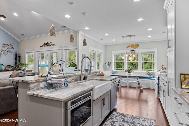 kitchen featuring a large island, plenty of natural light, white cabinets, and dark wood-type flooring