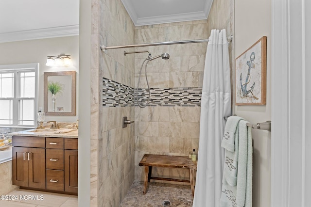 full bathroom with ornamental molding, tiled shower, and vanity