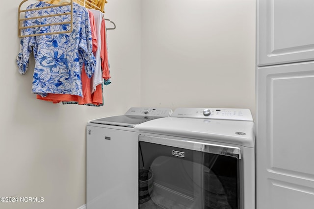 washroom with washing machine and clothes dryer