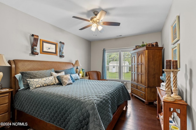 bedroom featuring dark wood-style floors and ceiling fan