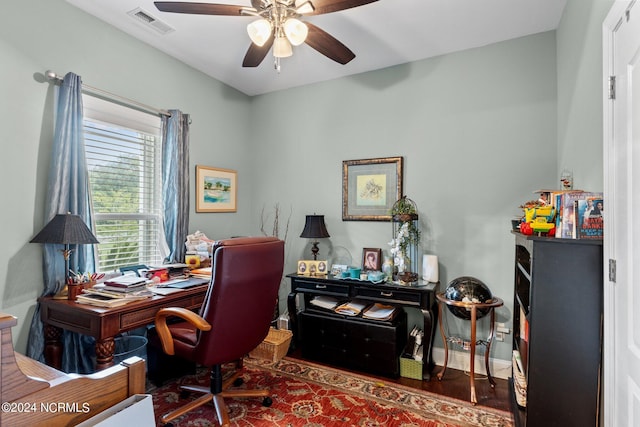 office area featuring visible vents, ceiling fan, baseboards, and wood finished floors