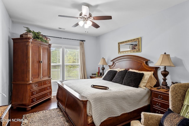 bedroom featuring dark wood-style floors, ceiling fan, and visible vents