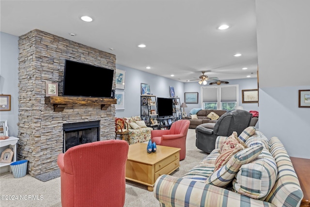 living area with ceiling fan, a stone fireplace, carpet flooring, and recessed lighting