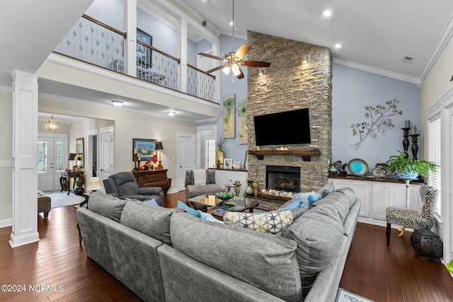 living room featuring high vaulted ceiling, dark wood-type flooring, crown molding, and a healthy amount of sunlight