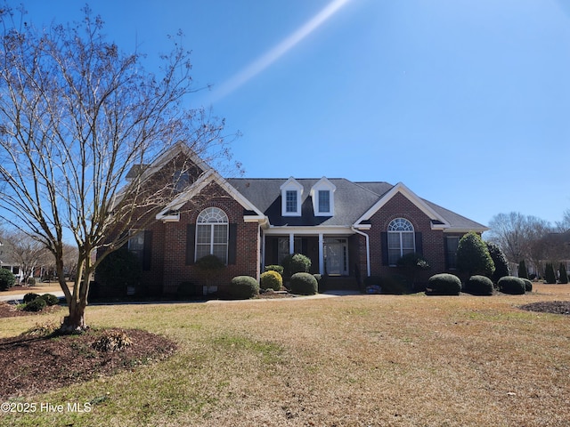 view of front of house with a front lawn and brick siding