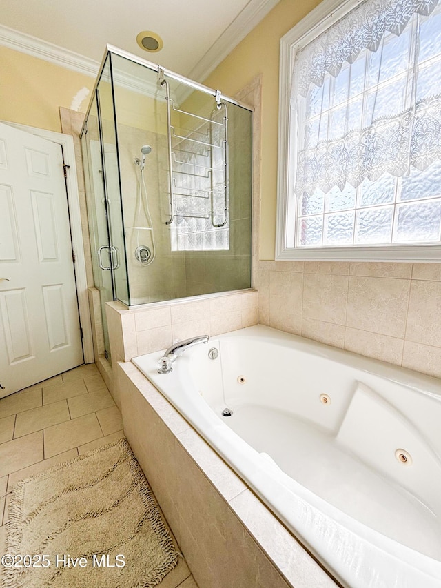 full bathroom with tile patterned floors, a tub with jets, a stall shower, and ornamental molding