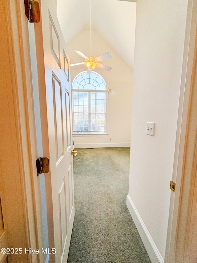 hall with lofted ceiling, carpet, baseboards, and visible vents