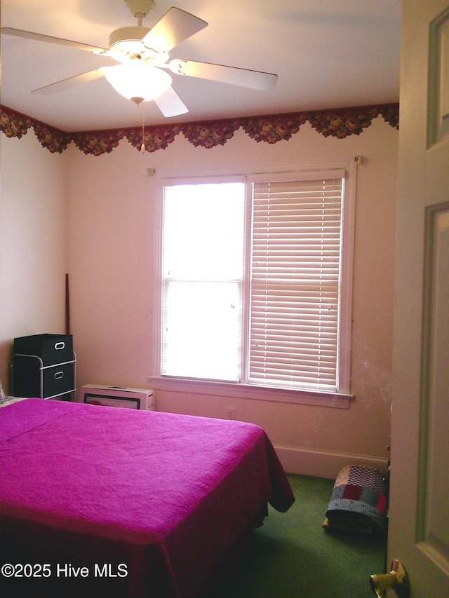 carpeted bedroom with baseboards and ceiling fan