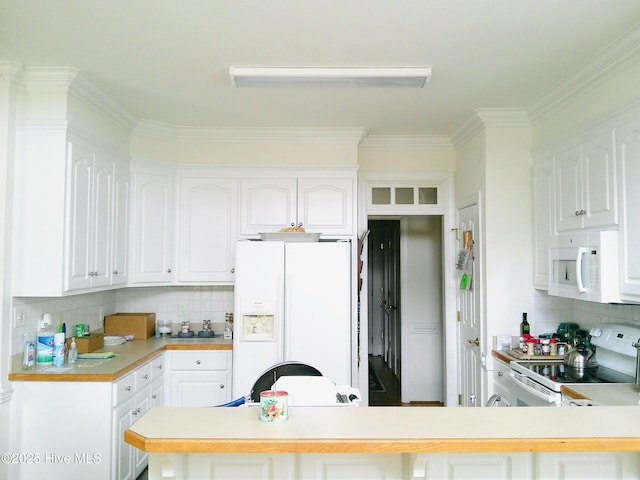 kitchen featuring white appliances, a peninsula, white cabinets, and light countertops