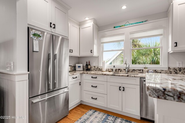 12 Killegray Rdg, Bald Head Island, NC 28461 - kitchen with appliances with stainless steel finishes, a sink, healthy amount of natural light, white cabinets, and recessed lighting