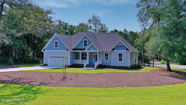 craftsman-style house with a front yard, covered porch, and a garage