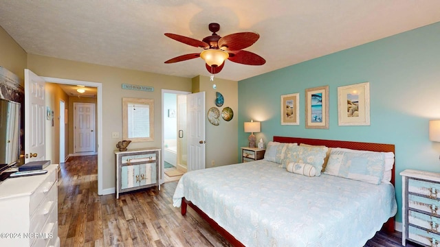 bedroom with connected bathroom, hardwood / wood-style flooring, and ceiling fan