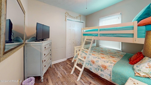 bedroom featuring light hardwood / wood-style floors and a closet