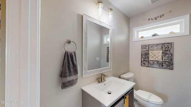 bathroom featuring vanity and toilet