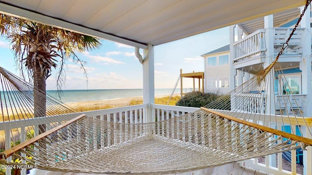 deck featuring a water view and a view of the beach