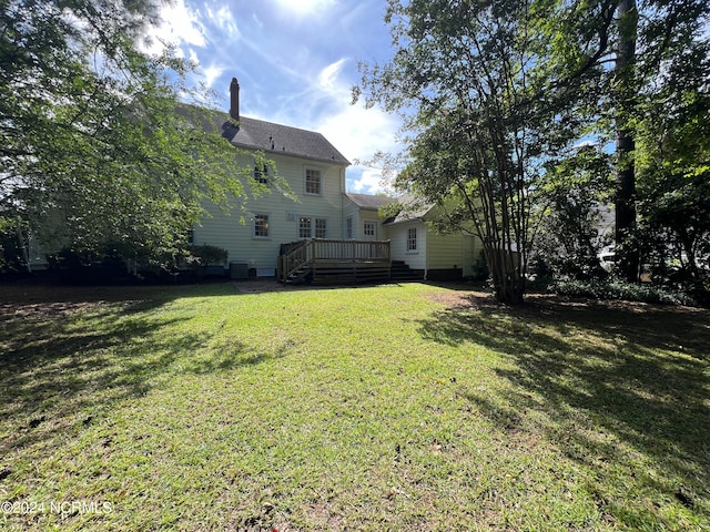 view of yard featuring central AC and a deck