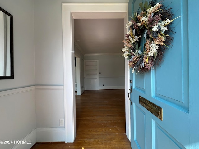 entrance foyer with crown molding and dark hardwood / wood-style flooring