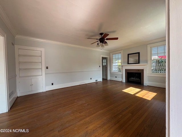 unfurnished living room with built in shelves, crown molding, dark hardwood / wood-style flooring, and ceiling fan