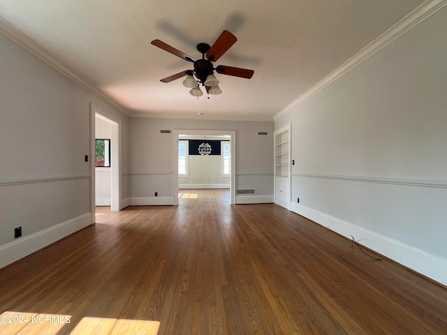 unfurnished room with ornamental molding, built in shelves, hardwood / wood-style flooring, and ceiling fan