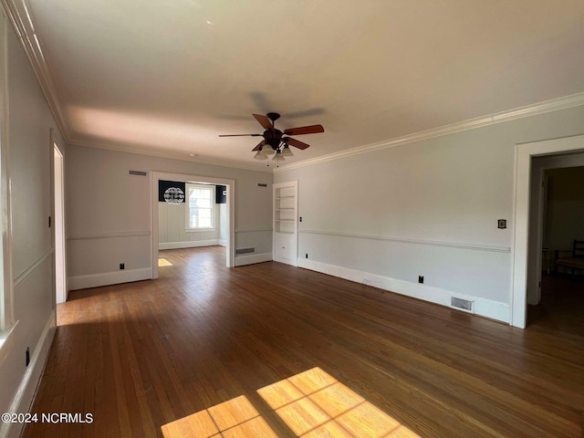 spare room with crown molding, ceiling fan, and dark hardwood / wood-style floors