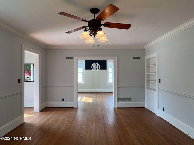 spare room featuring ceiling fan, ornamental molding, and dark wood-type flooring