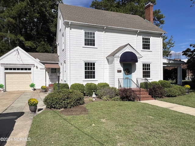 view of front of home with a garage and a front yard