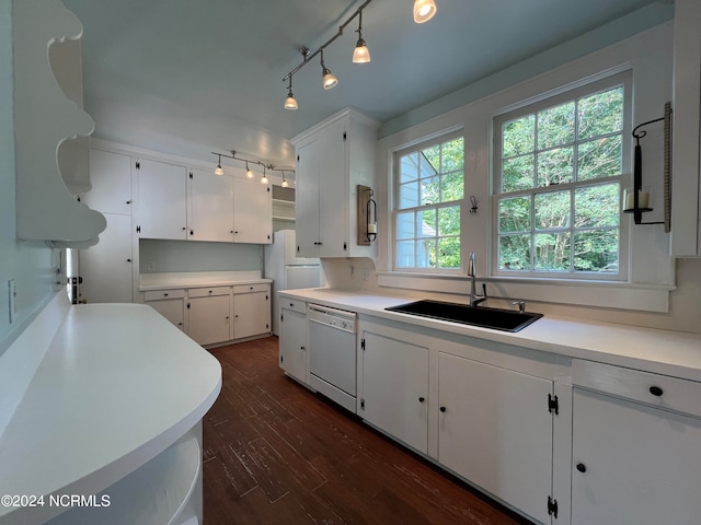 kitchen featuring decorative light fixtures, sink, dishwasher, dark hardwood / wood-style floors, and white cabinets