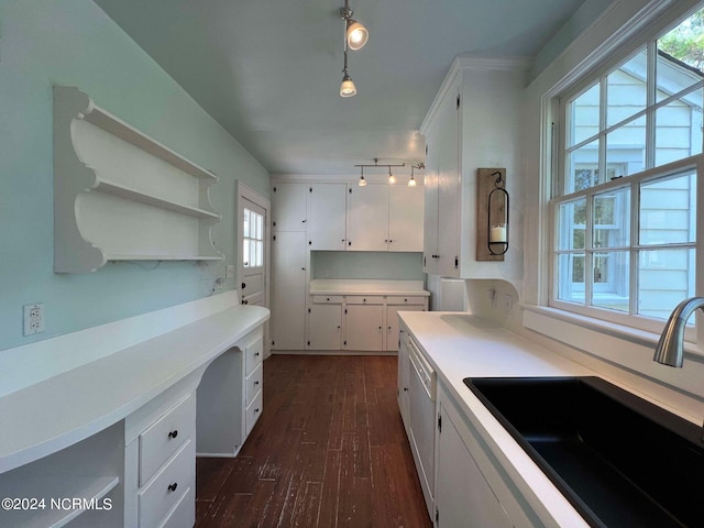 kitchen featuring hanging light fixtures, white cabinets, sink, and dark hardwood / wood-style flooring