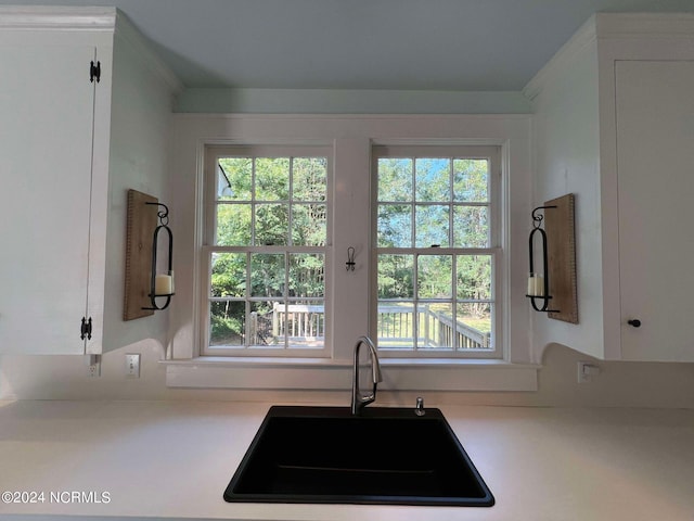 kitchen featuring white cabinets and sink