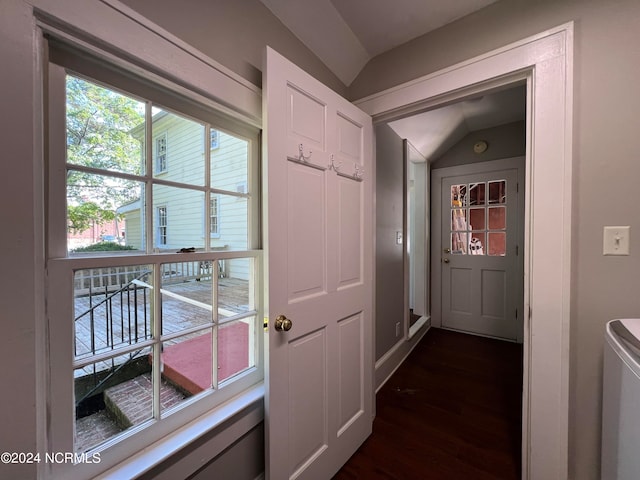 doorway to outside featuring dark wood-type flooring and vaulted ceiling