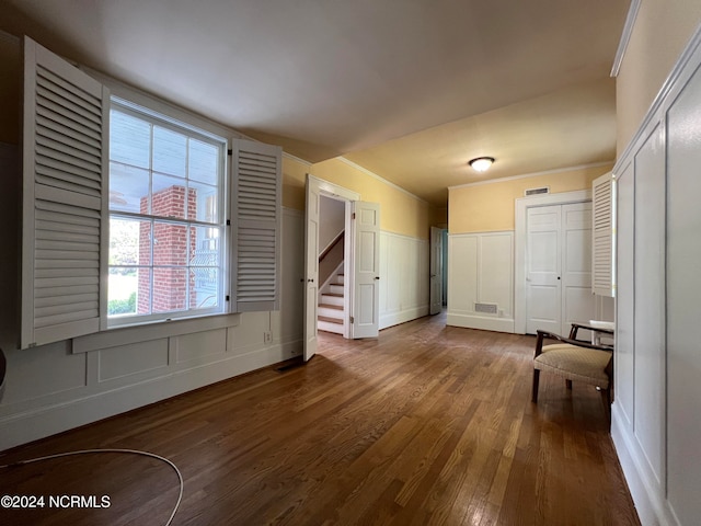 interior space featuring crown molding and hardwood / wood-style flooring