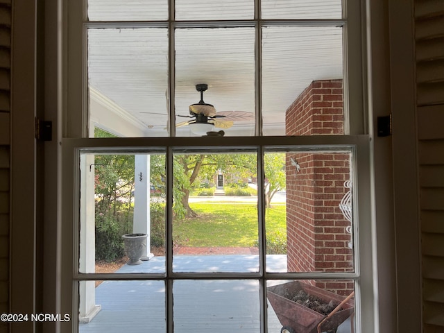 interior details featuring ceiling fan and ornamental molding