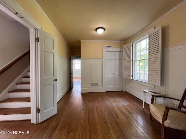 interior space with crown molding and dark hardwood / wood-style flooring