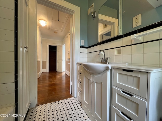 bathroom with decorative backsplash and hardwood / wood-style flooring