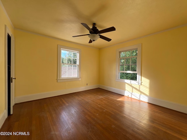 empty room featuring hardwood / wood-style flooring, crown molding, and ceiling fan