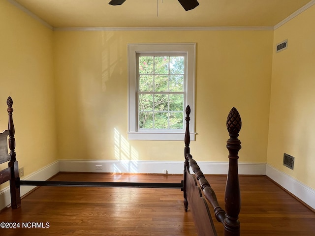 interior space featuring ceiling fan, dark hardwood / wood-style floors, and ornamental molding