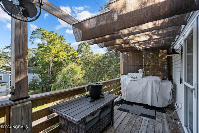 wooden deck with grilling area and a pergola