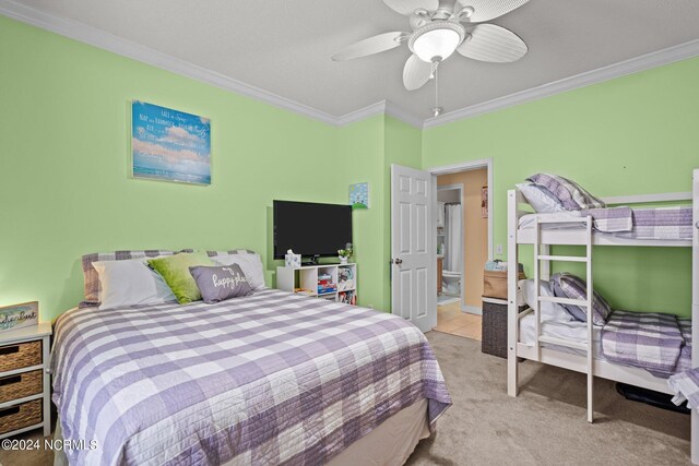 bedroom with crown molding, ceiling fan, and light colored carpet