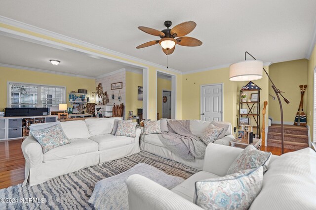 living room with ceiling fan, ornamental molding, and hardwood / wood-style flooring