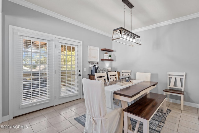 dining room with ornamental molding, baseboards, and light tile patterned floors