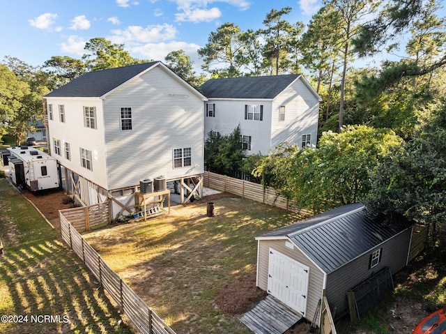 rear view of property with a fenced backyard and a lawn