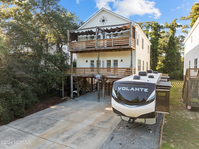 view of front of property featuring a carport and a wooden deck