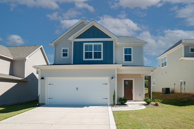 view of front of house with central AC unit, an attached garage, driveway, a front lawn, and board and batten siding