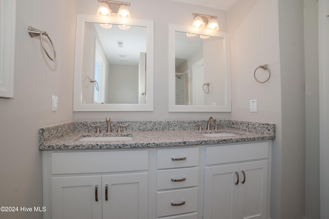 full bath featuring visible vents, a sink, and double vanity