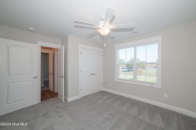 unfurnished bedroom with visible vents, a ceiling fan, baseboards, a closet, and carpet